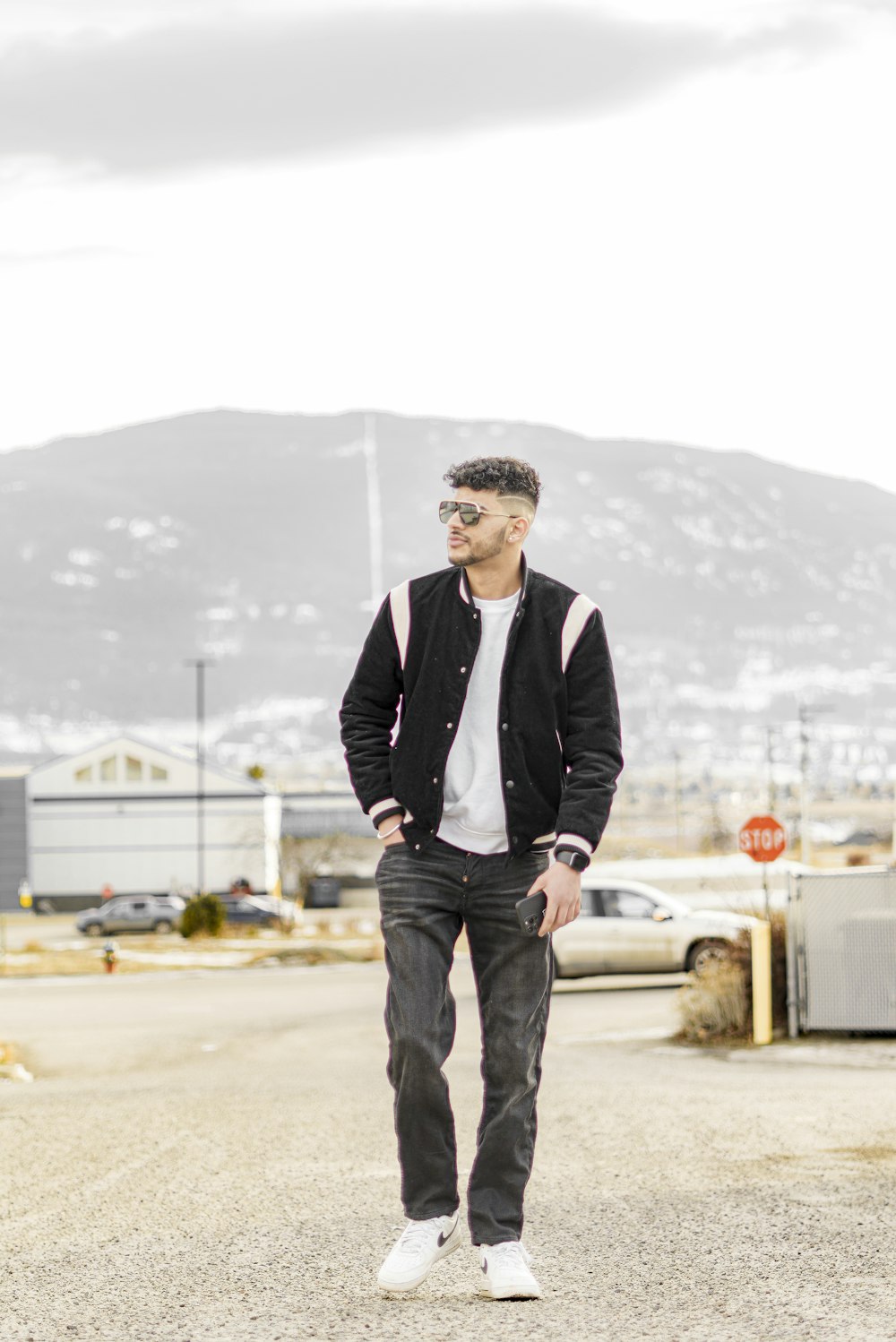 a man standing in the middle of a parking lot