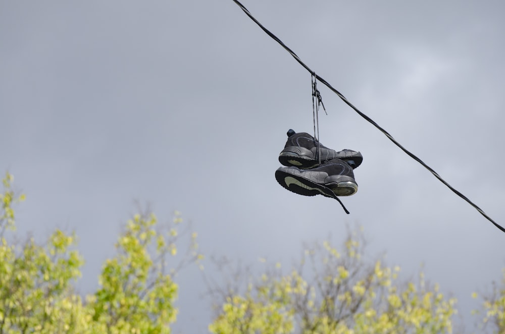 a pair of shoes hanging from a power line
