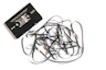 a pile of black cords next to a cassette