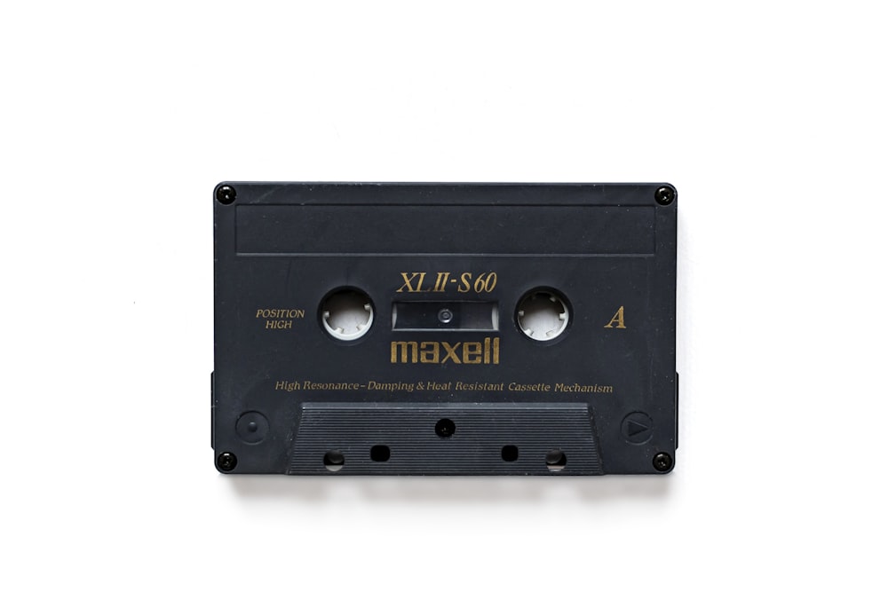 a black cassette with gold lettering on it