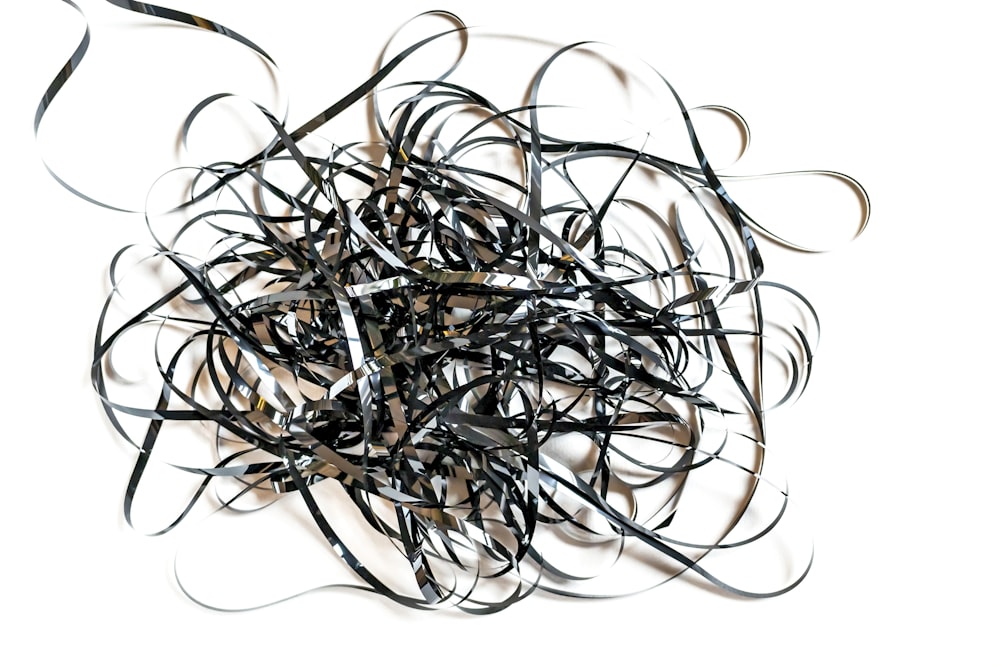 a pile of black rubber bands on a white background