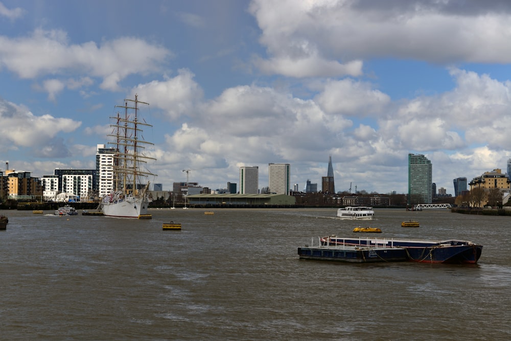 a large boat floating on top of a river next to tall buildings