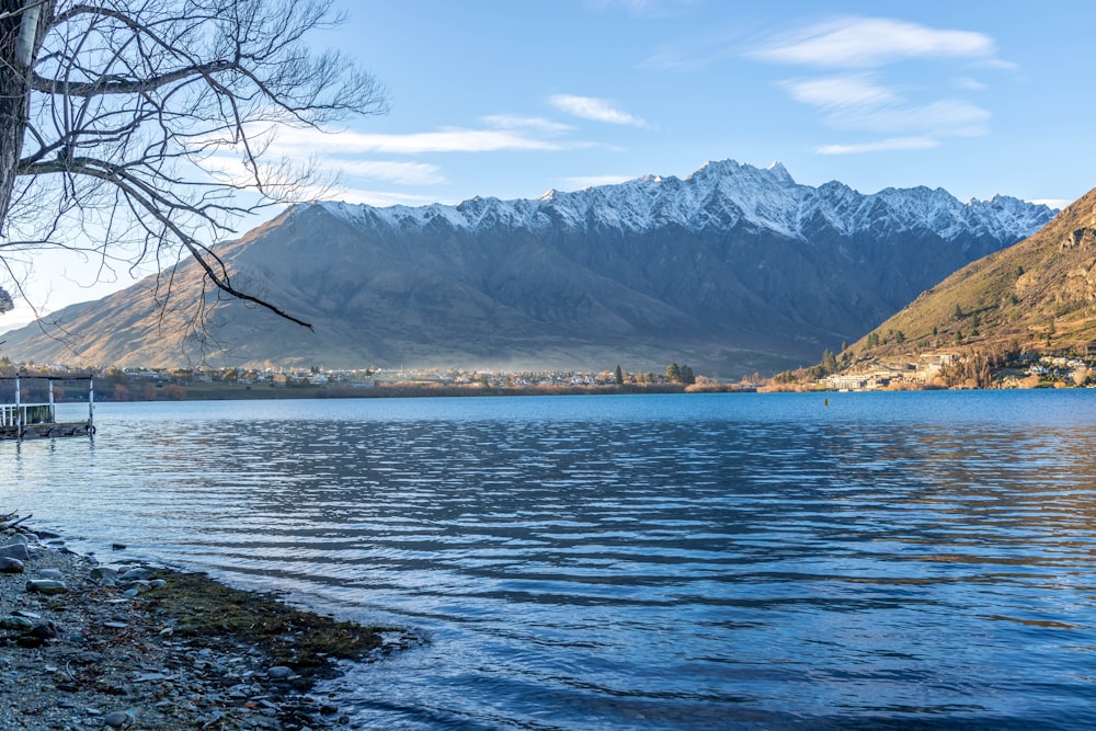 a body of water with mountains in the background