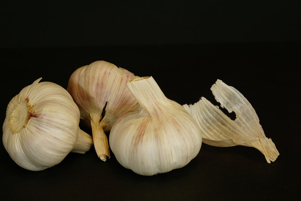 a couple of garlics sitting on top of a table