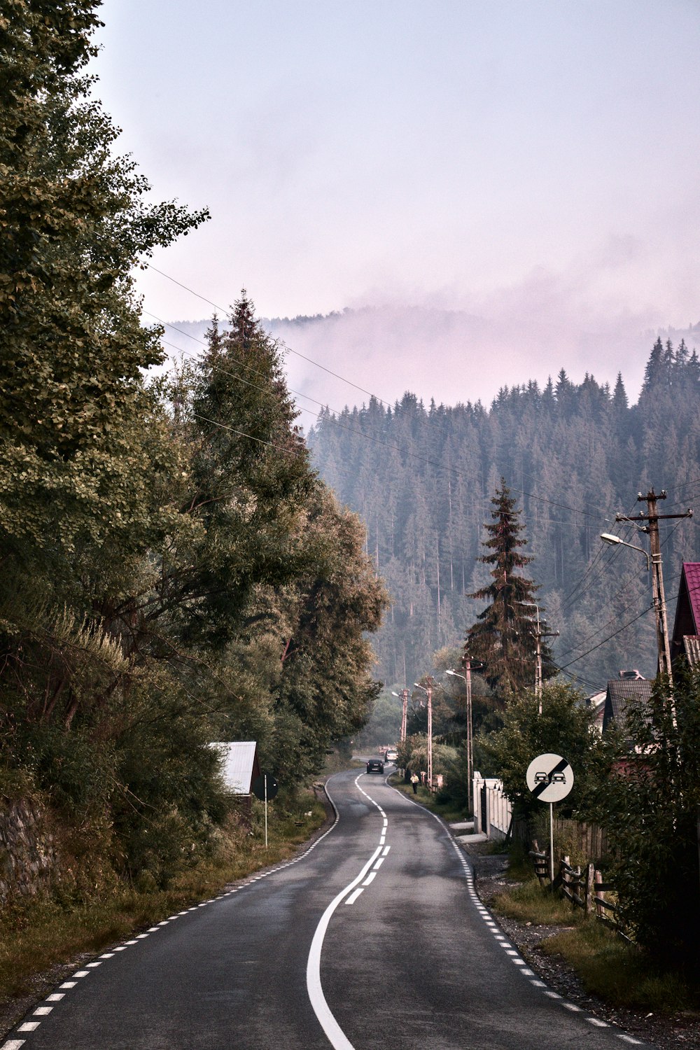 an empty road with a mountain in the background