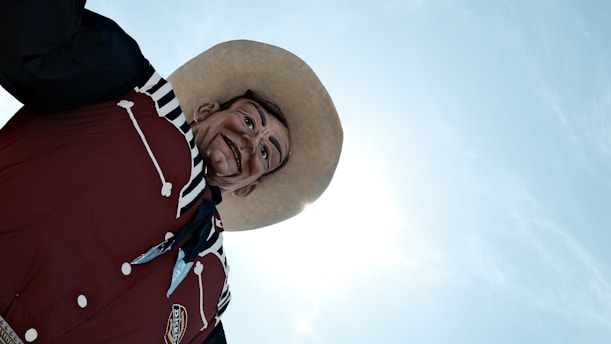 big tex wearing a hat and a red jacket
