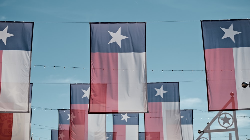 a bunch of flags that are hanging in the air