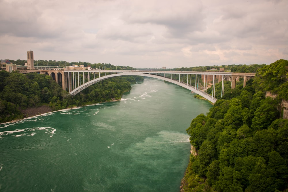 a bridge over a river with a bridge in the background