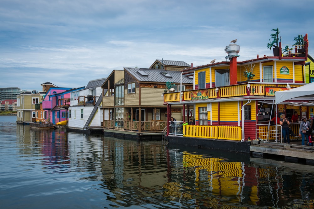 a row of houses sitting next to a body of water