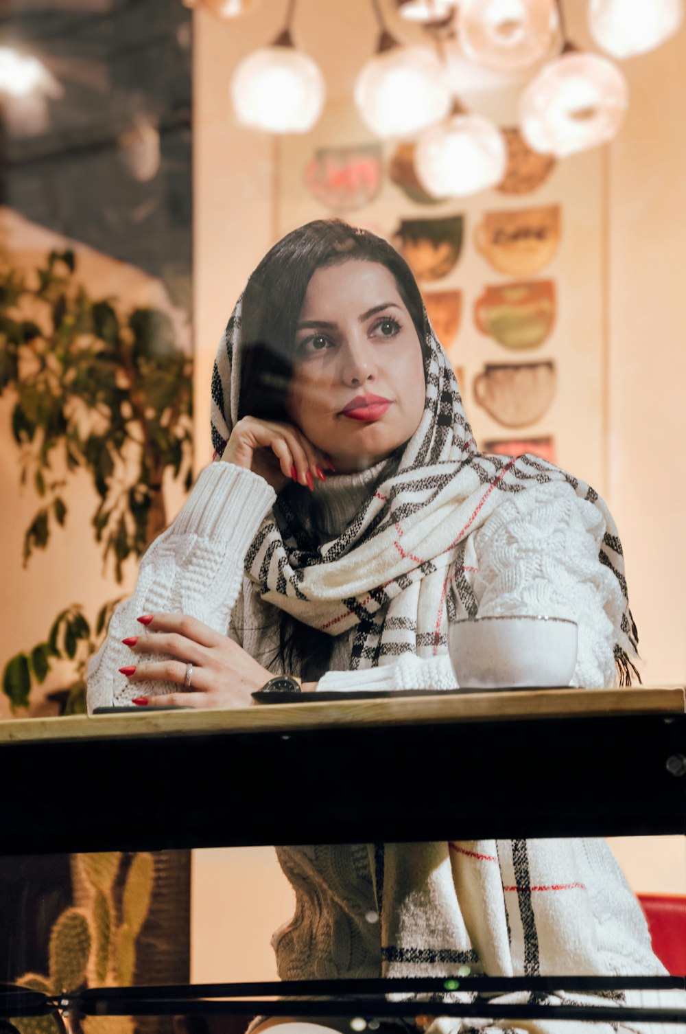 a woman in a scarf talking on a cell phone