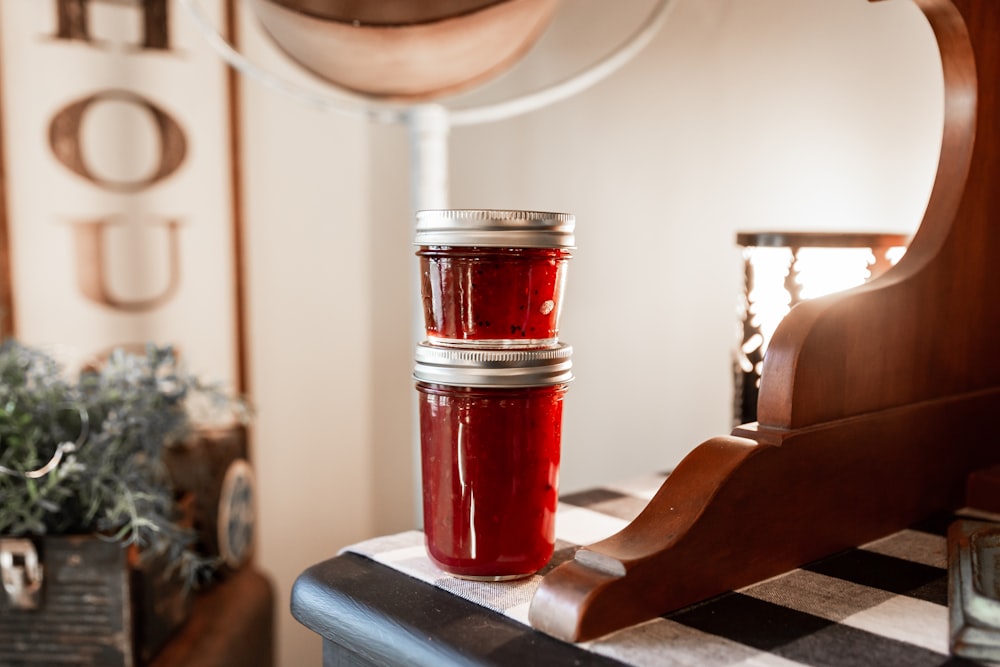 three jars of jam sitting on a table