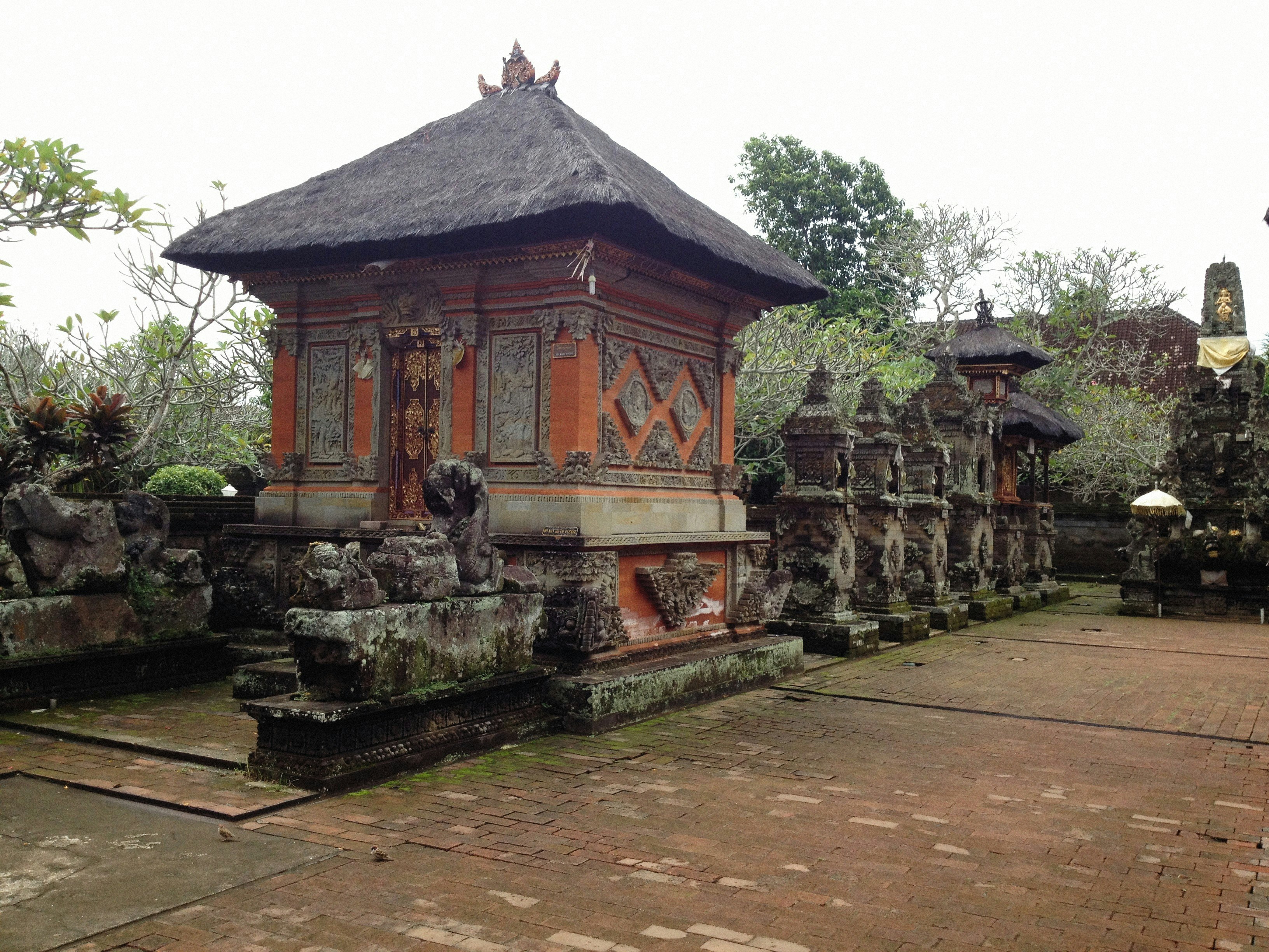 Batuan Village — Ancient stone shrine and multi-tiered pavilion within the sanctified middle courtyard (Madya Mandala) of Pura Puseh.