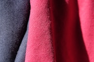 All three tunics displayed side-by-side on mannequins in a softly lit room, emphasizing their color contrast and luxurious feel.