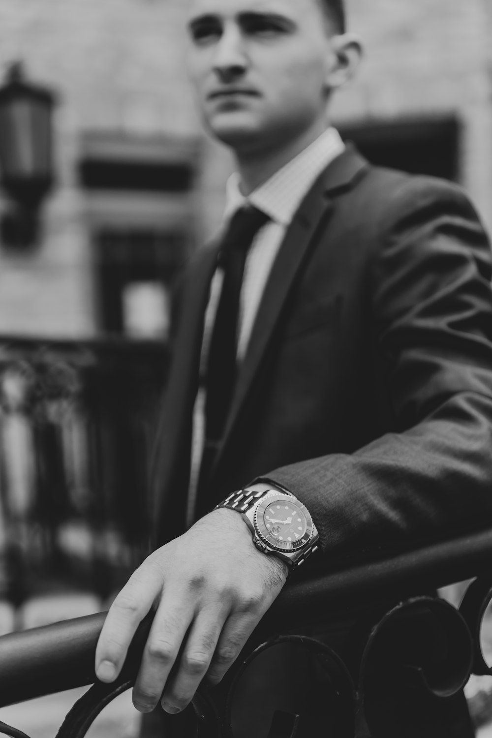 a black and white photo of a man in a suit and tie