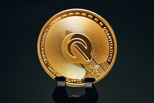 Close-up of a gleaming gold coin resting on a digital ledger screen displaying secure transaction data.