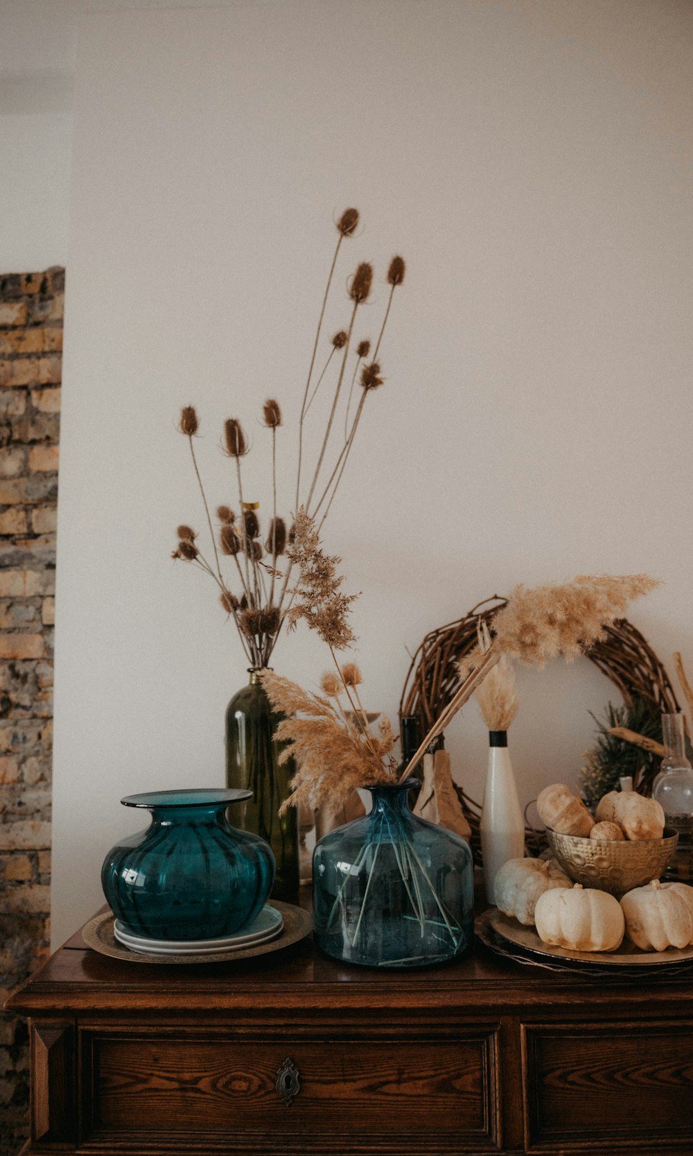 a wooden table topped with vases filled with flowers