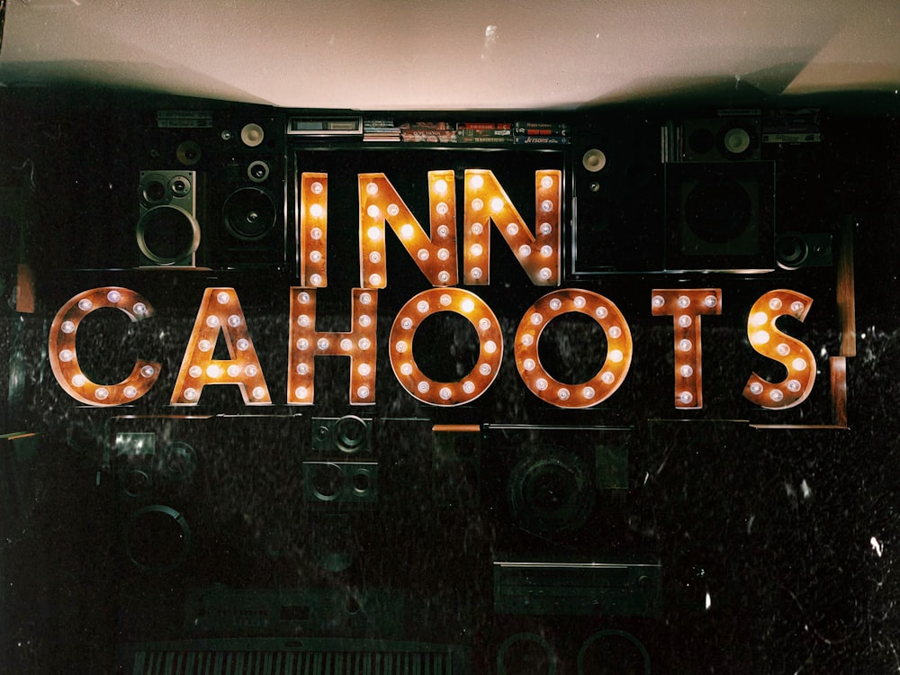 a neon sign that says inn cahoots on it