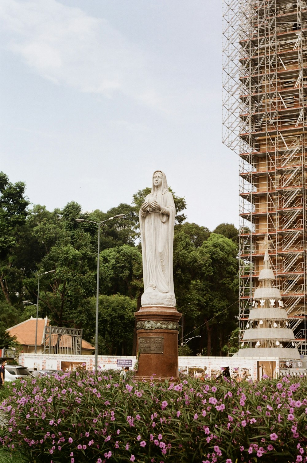 a statue of a woman in front of a tall building