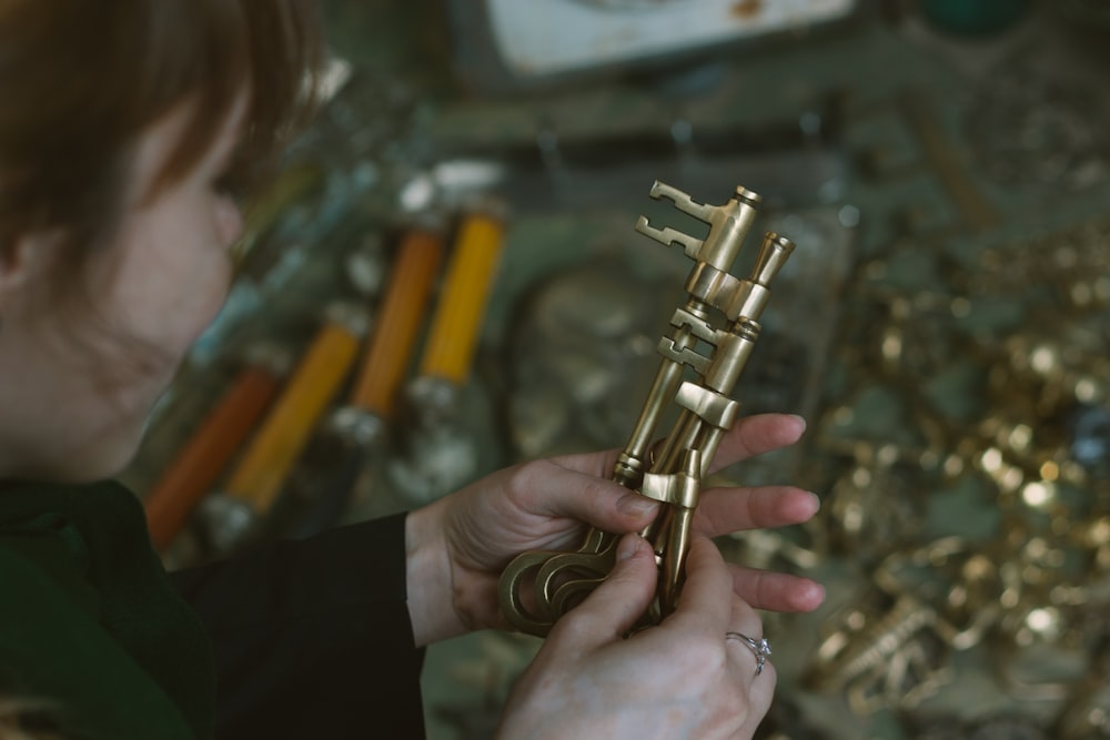 a close up of a person holding a metal object