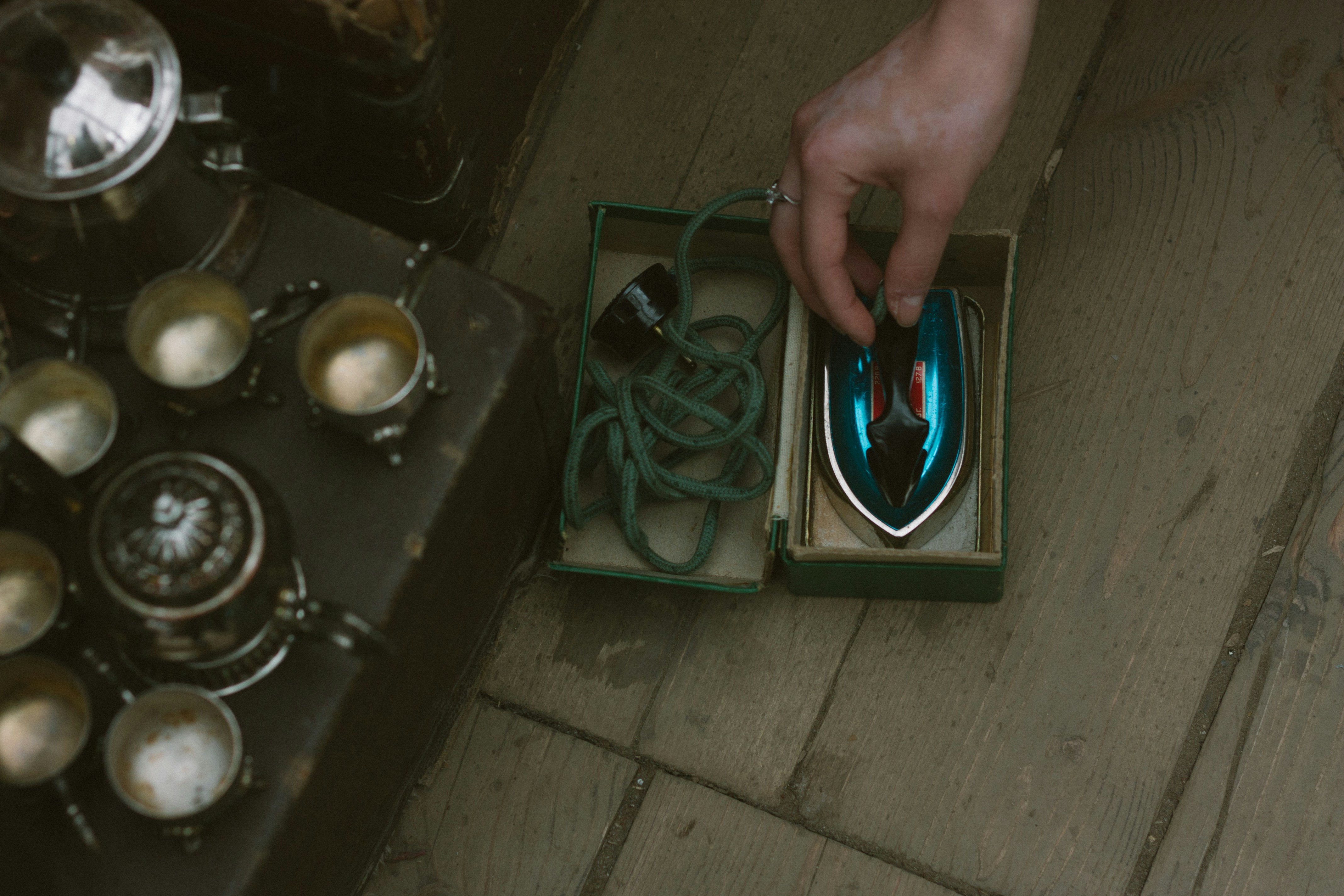 a person is holding a mouse in a box