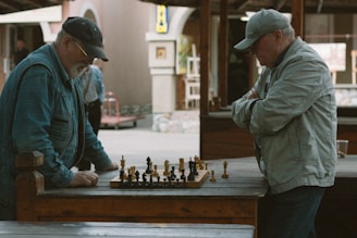 two men playing a game of chess on a table