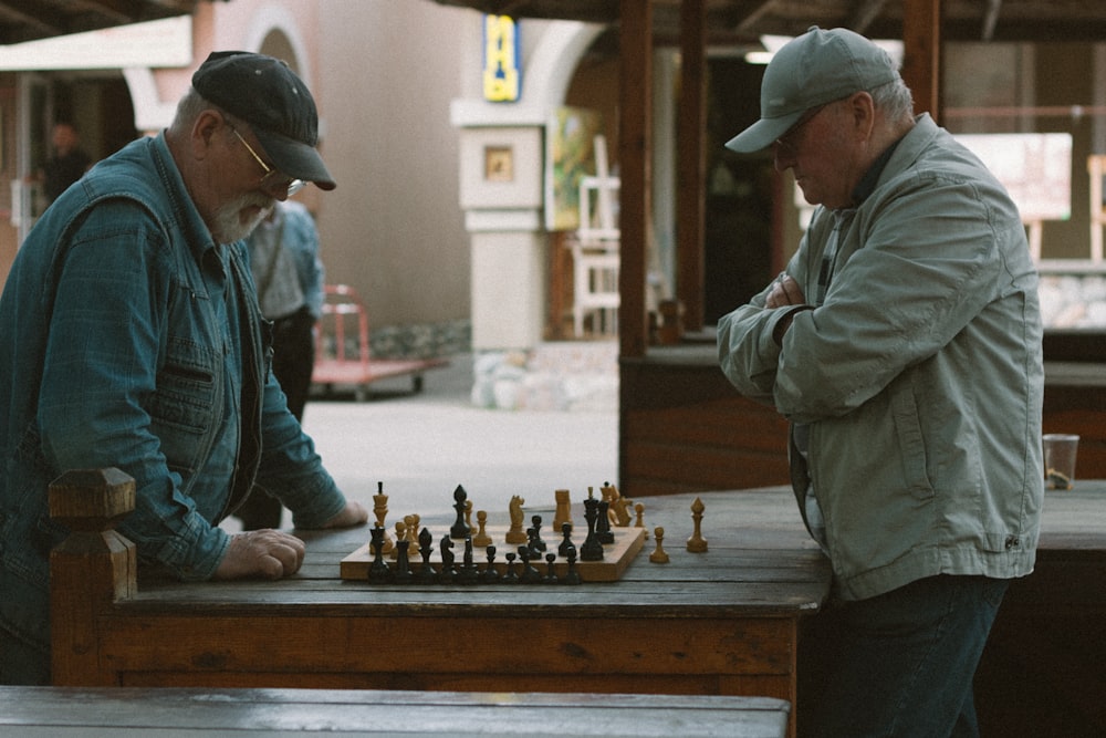 two men playing a game of chess on a table