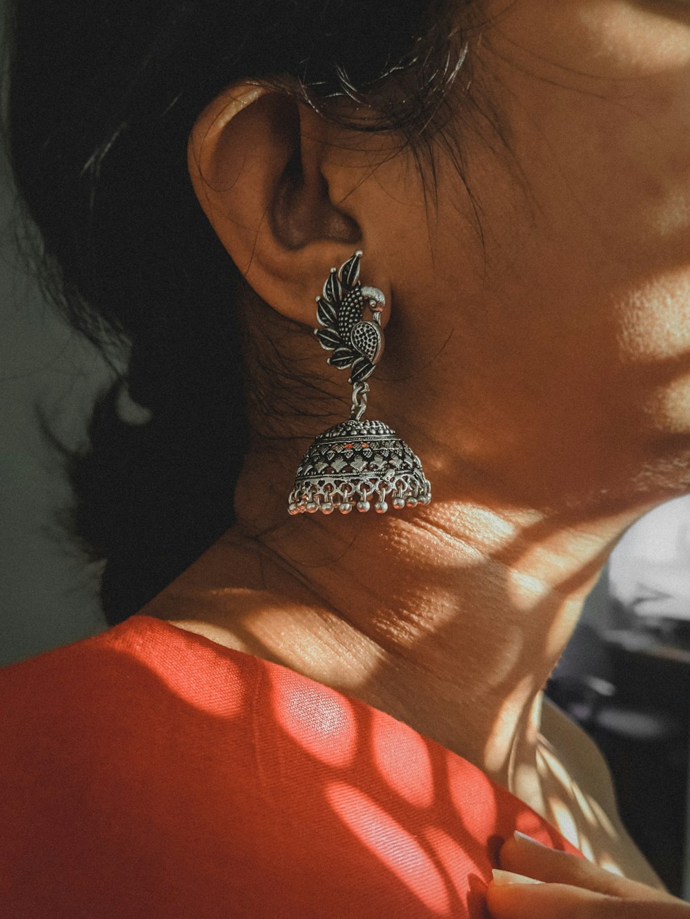 a close up of a person wearing a pair of earrings