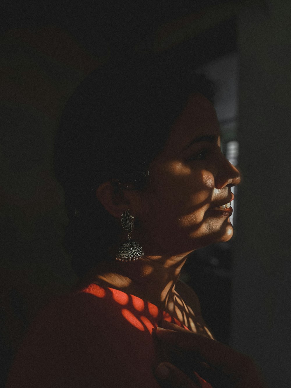 a woman in a red dress looking off into the distance