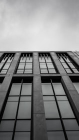 Architectural wireframe overlay on a sleek industrial building facade.