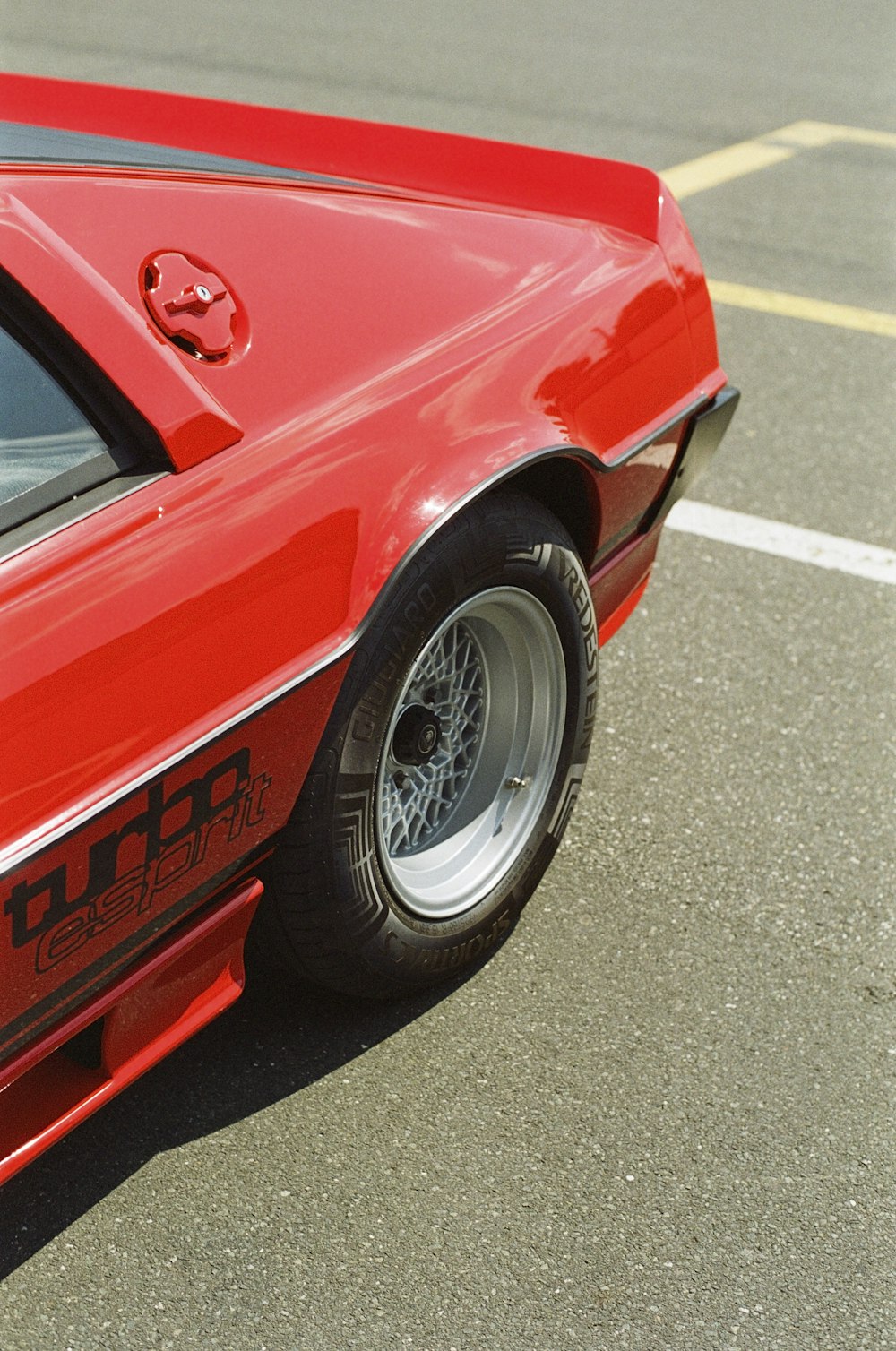 a red sports car parked in a parking lot