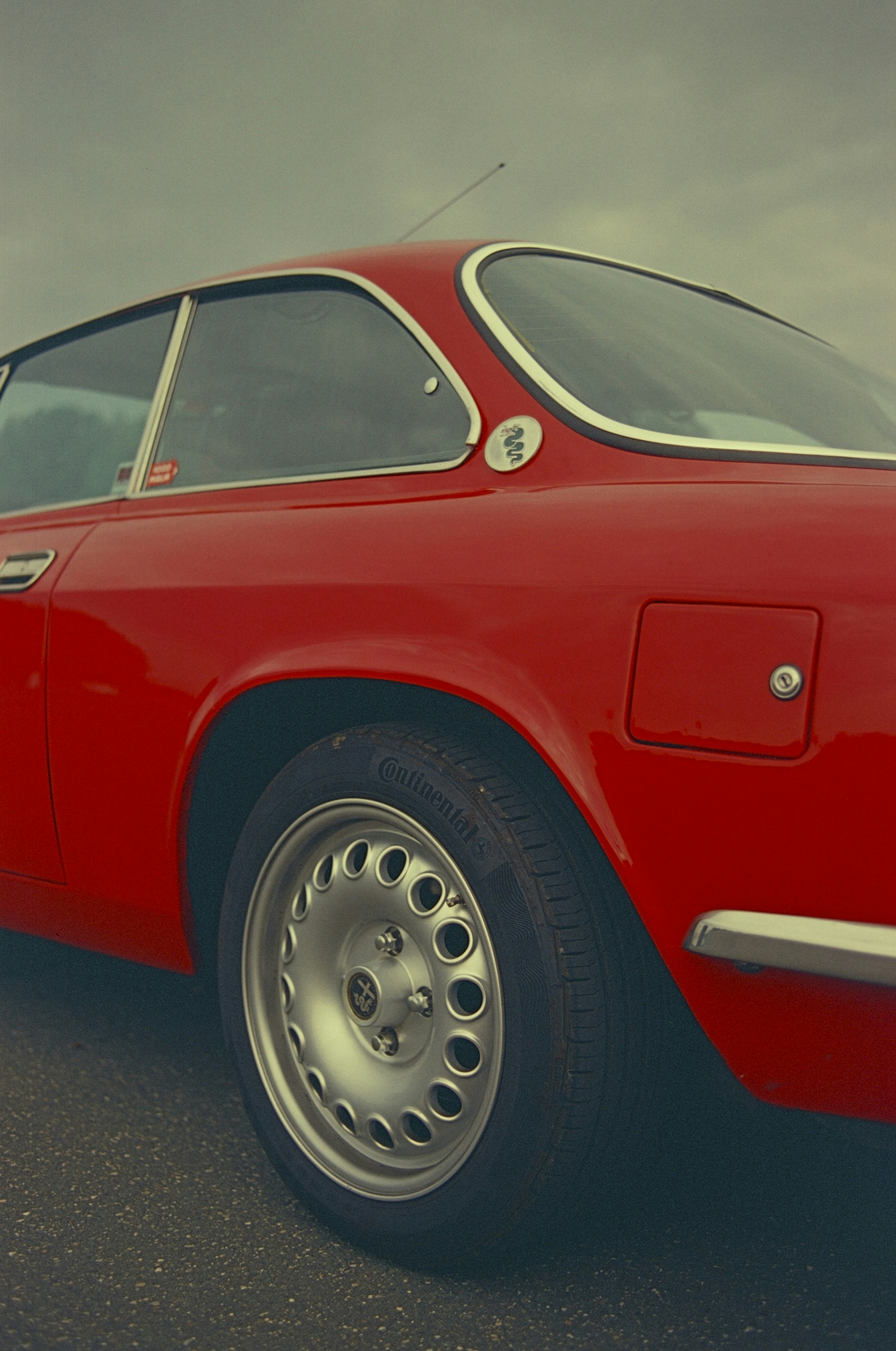 Red italian style iconic car Alfa Romeo Giulia GT 1600 Junior from 1974. Leica R7 (1994), Summicron-R 2.0 35mm (1978). Hi-Res analog scan by www.totallyinfocus.com - Kodak Elite Chrome 100 (expired 2001)