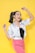 A joyful person taking a selfie in a well-lit studio with professional cameras.