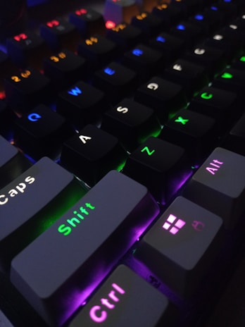 Close-up of a mechanical keyboard with customizable keycaps and lighting.