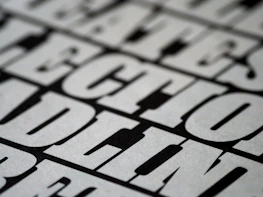 Close-up of oversized typography bleeding off the edge on a stark black background, emphasizing minimalism.