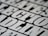 A close-up view of bold, black and white text with a slightly blurred effect, giving the impression of a print or poster design. The letters are large and occupy much of the frame, creating a striking visual impact.