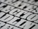A close-up view of bold, black and white text with a slightly blurred effect, giving the impression of a print or poster design. The letters are large and occupy much of the frame, creating a striking visual impact.