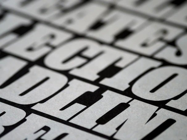 Close-up of a black t-shirt with a striking graffiti-style graphic and bold lettering.