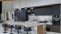 a modern kitchen with marble counter tops and stools