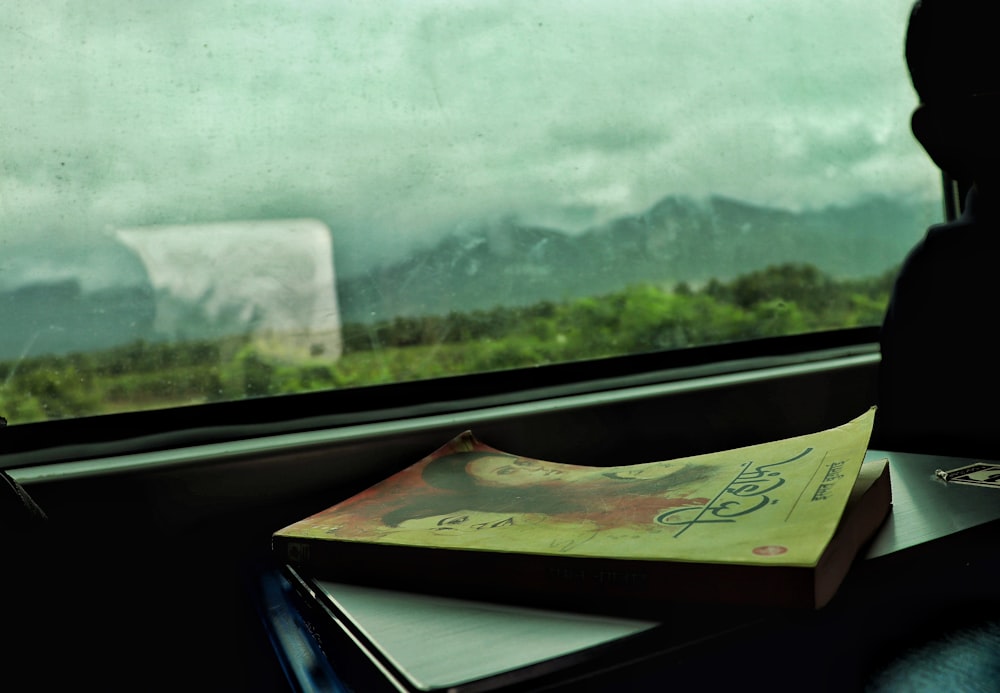 a book sitting on top of a table next to a window