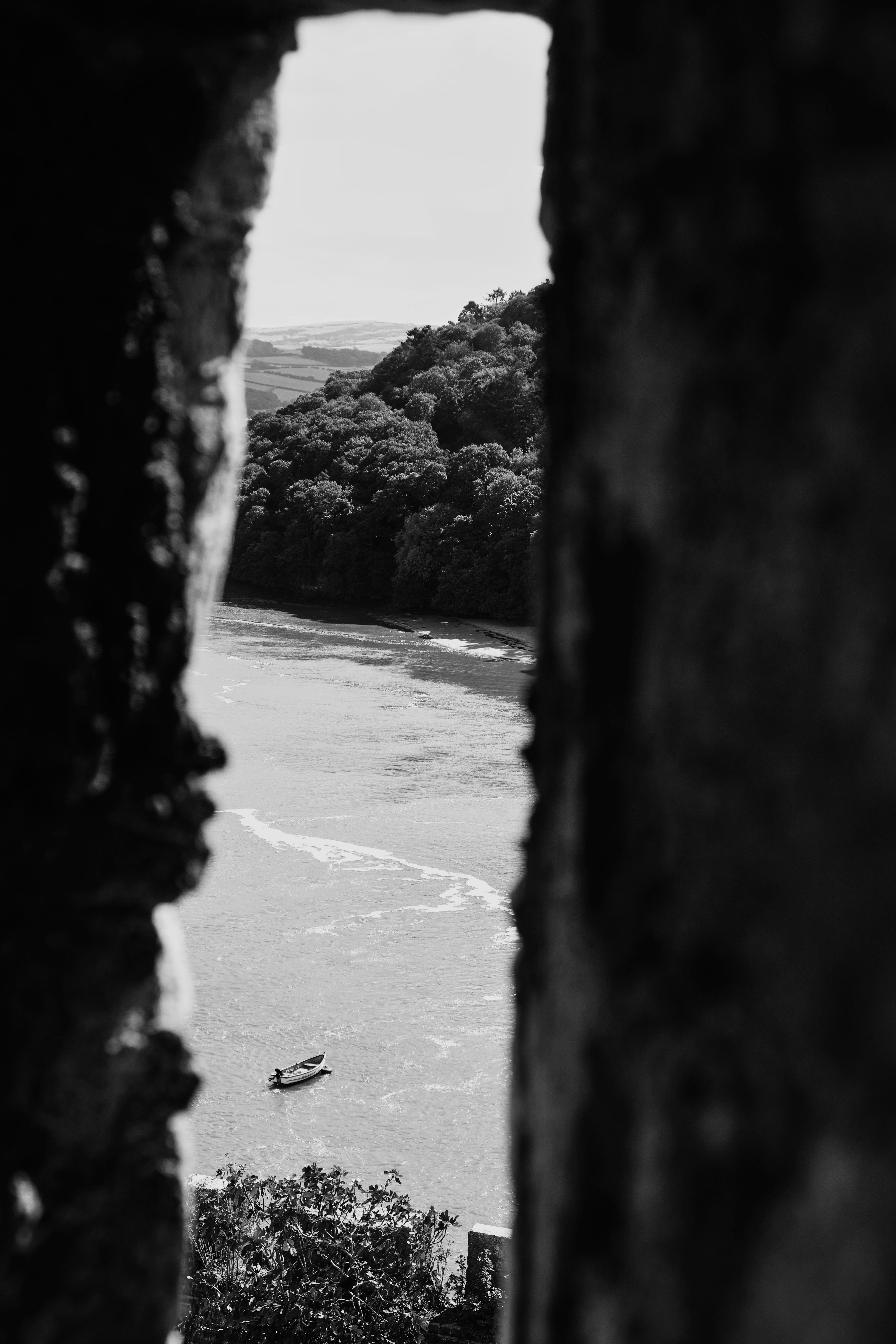 a black and white photo of a boat in the water