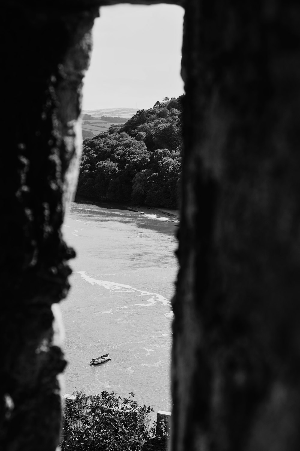 a black and white photo of a boat in the water