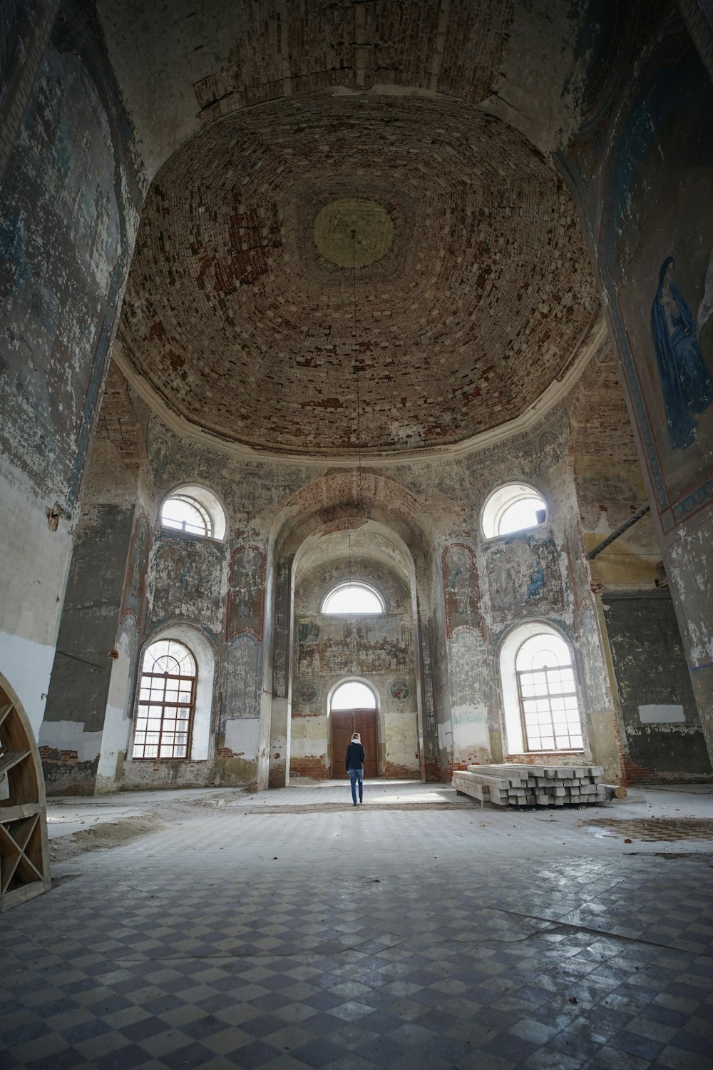 a person standing in a large room with two windows