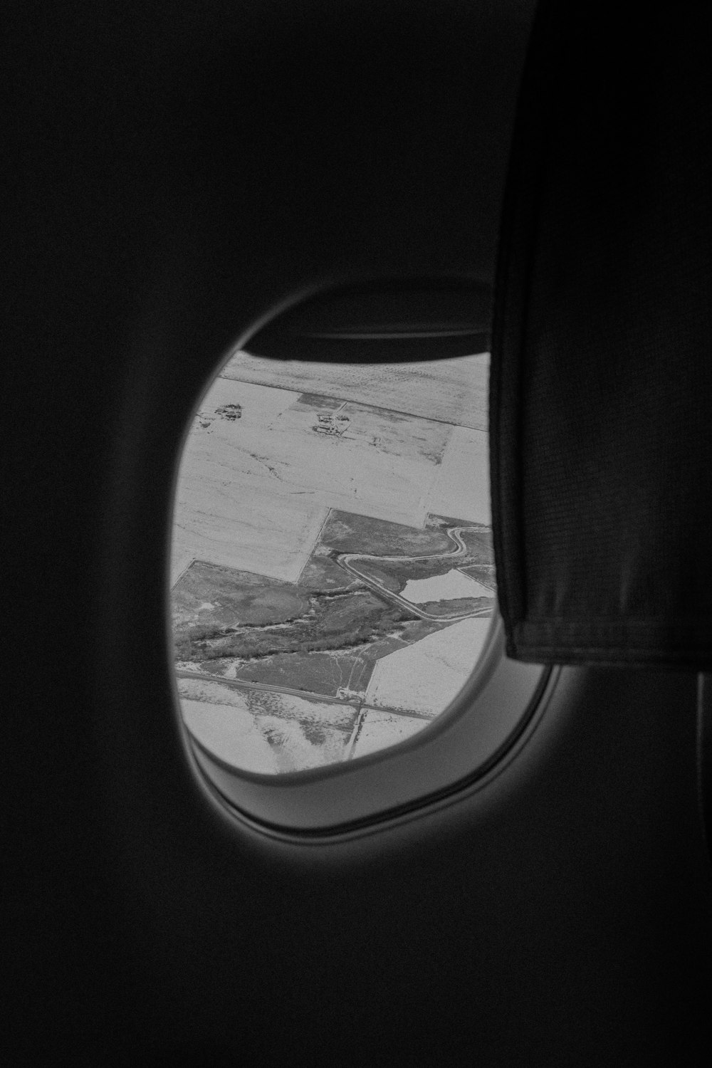 an airplane window with a view of the ground