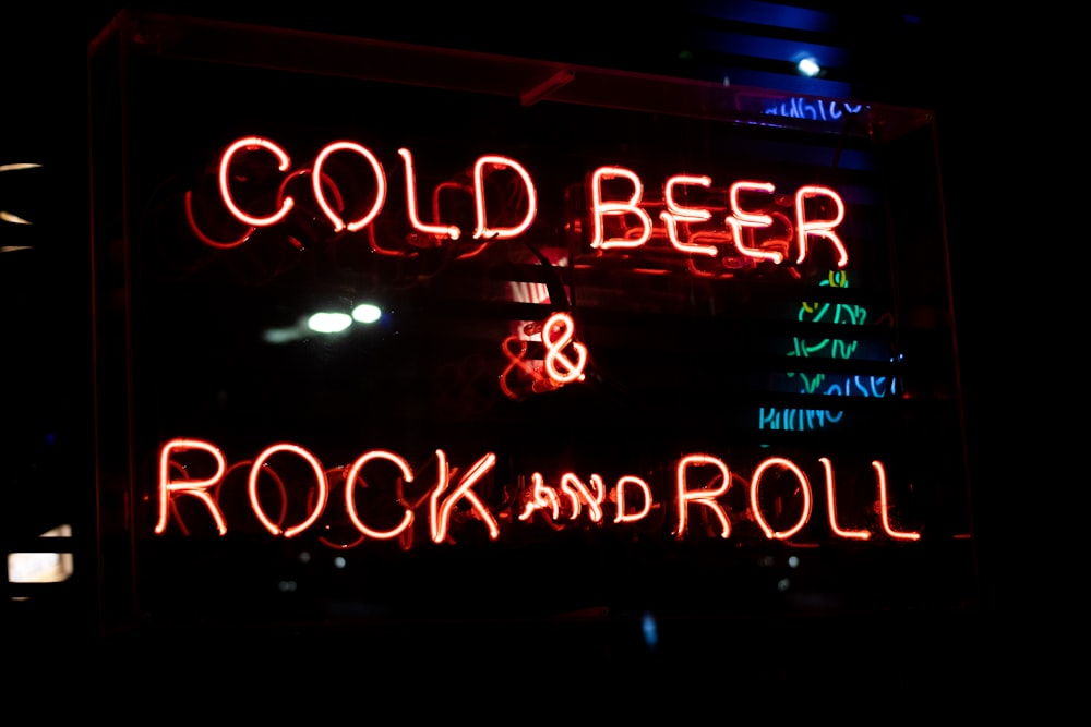 a neon sign that says cold beer and rock and roll