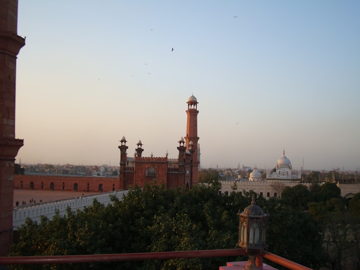 Sunrise view of the Red Fort in Delhi with warm golden hues illuminating the historic walls.