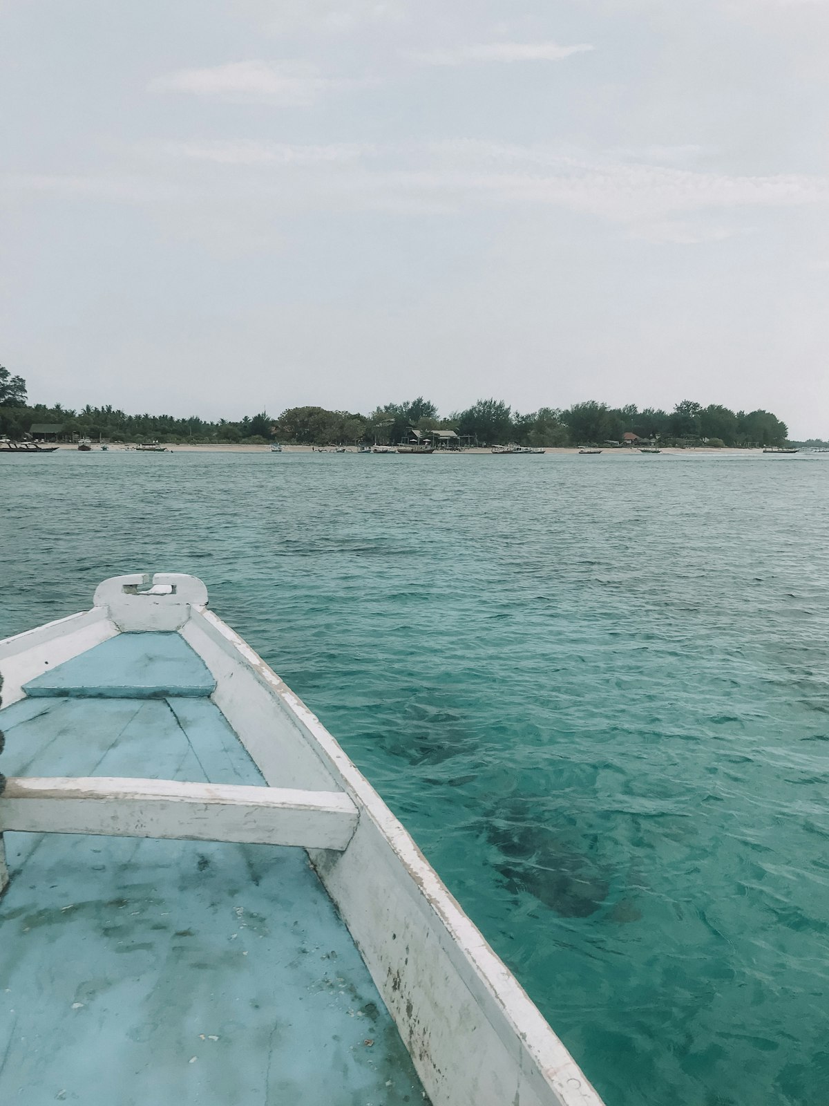 Kuta Lombok — crescent bay with turquoise surf and Sasak fishing boats on the south coast