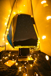 A cozy camp setup with warm lighting under a starry night in the Himalayas.