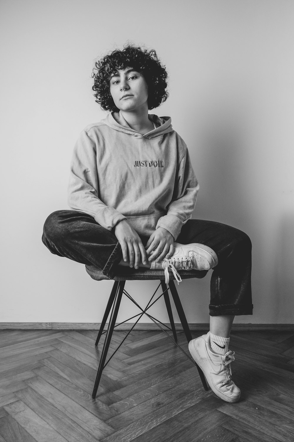 a black and white photo of a woman sitting on a chair