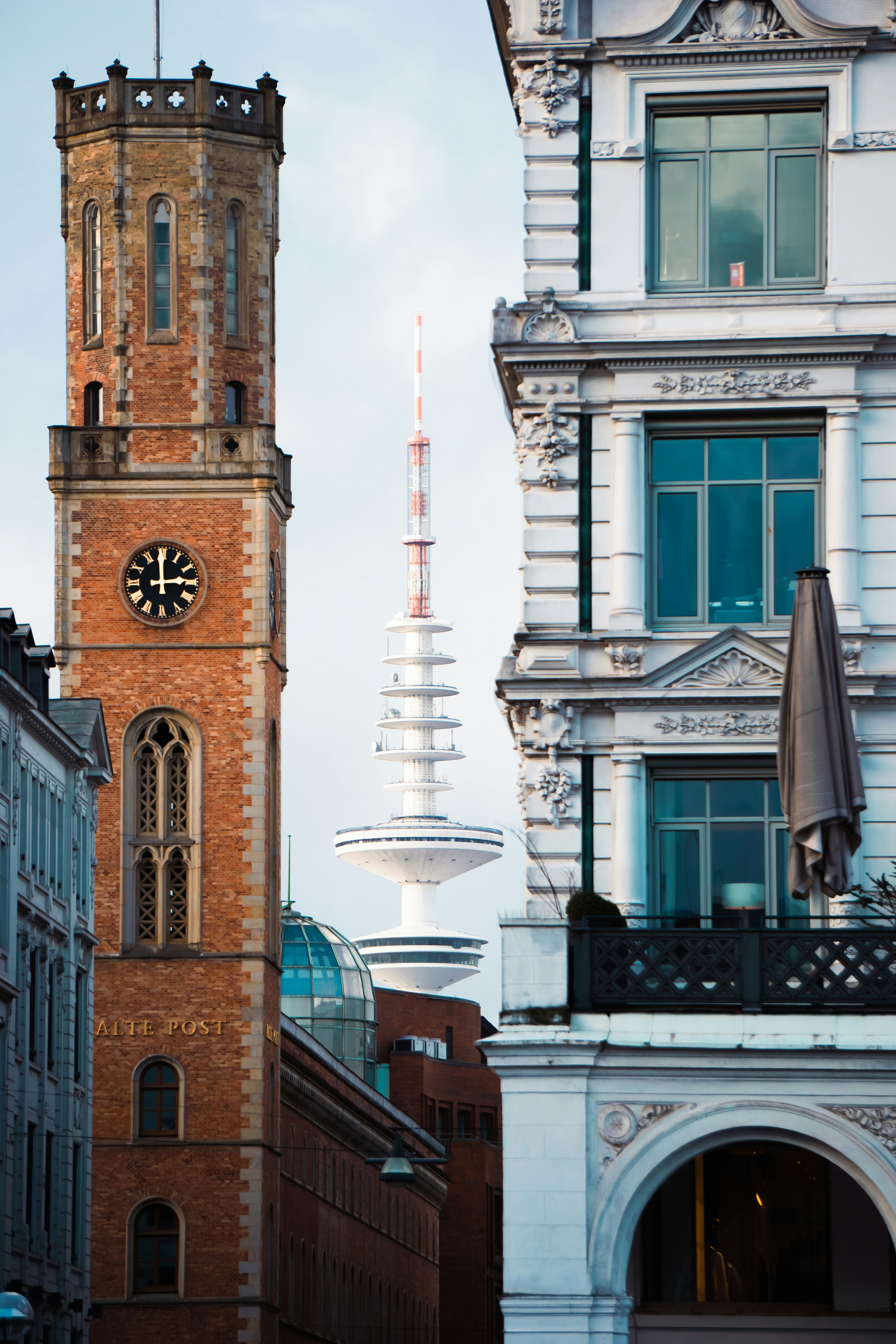 A tall clock tower towering over a city photo – Free Hamburg Image on ...