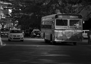 a black and white photo of a city bus